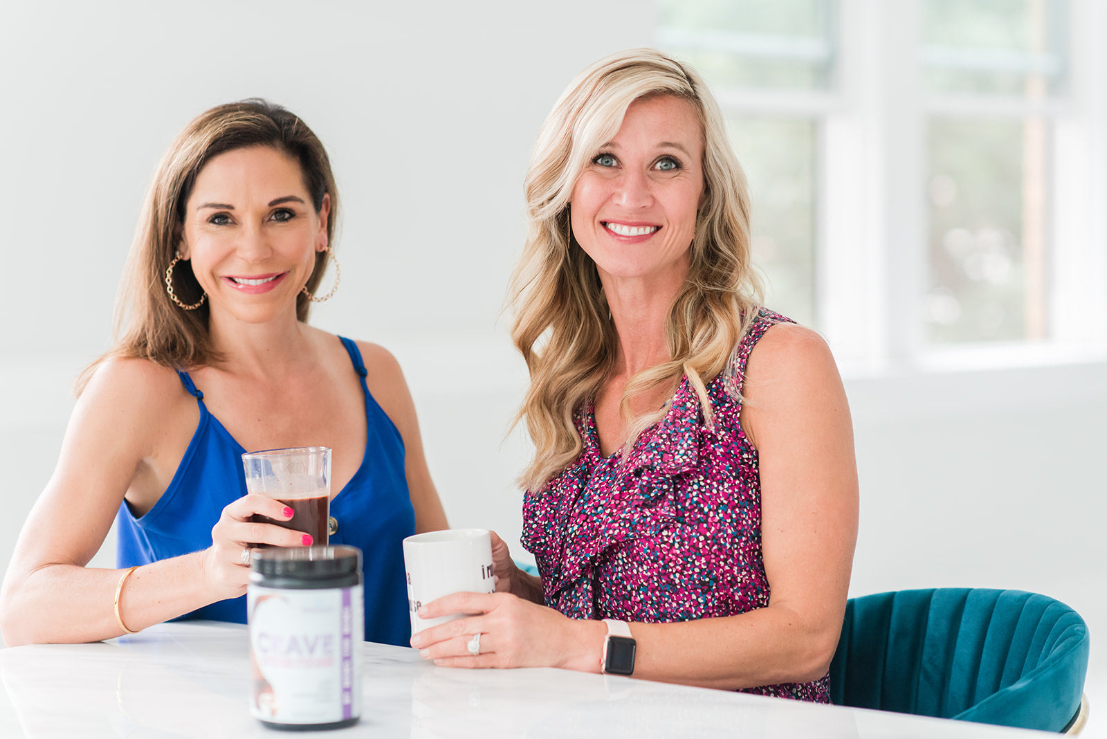 Coaches Emily and Debbie enjoy a cup of nutritious Crave cocoa powder blend